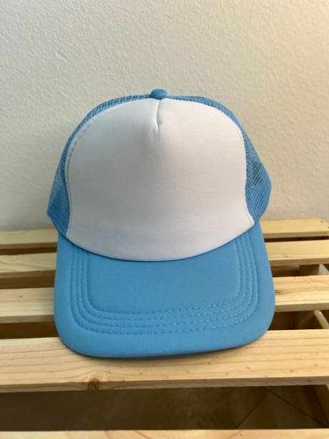 A blue and white hat sitting on top of a wooden bench.