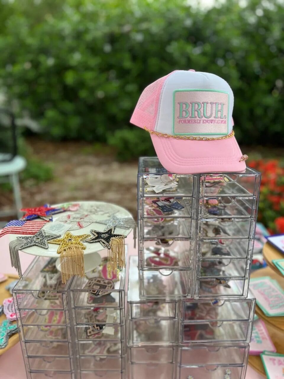 A pink and white hat sitting on top of some clear boxes.